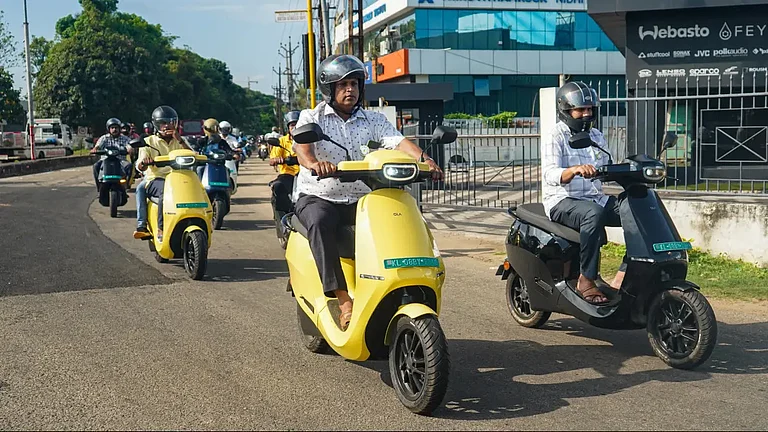 People riding Ola scooters - null