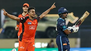 Umran Malik celebrates after dismissing Wriddhiman Saha in an IPL 2022 match on Wednesday.
