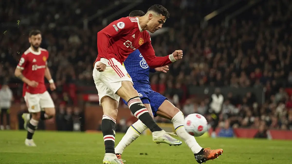 Manchester United's Cristiano Ronaldo scores a goal against Chelsea during their English Premier League match at Old Trafford Stadium.