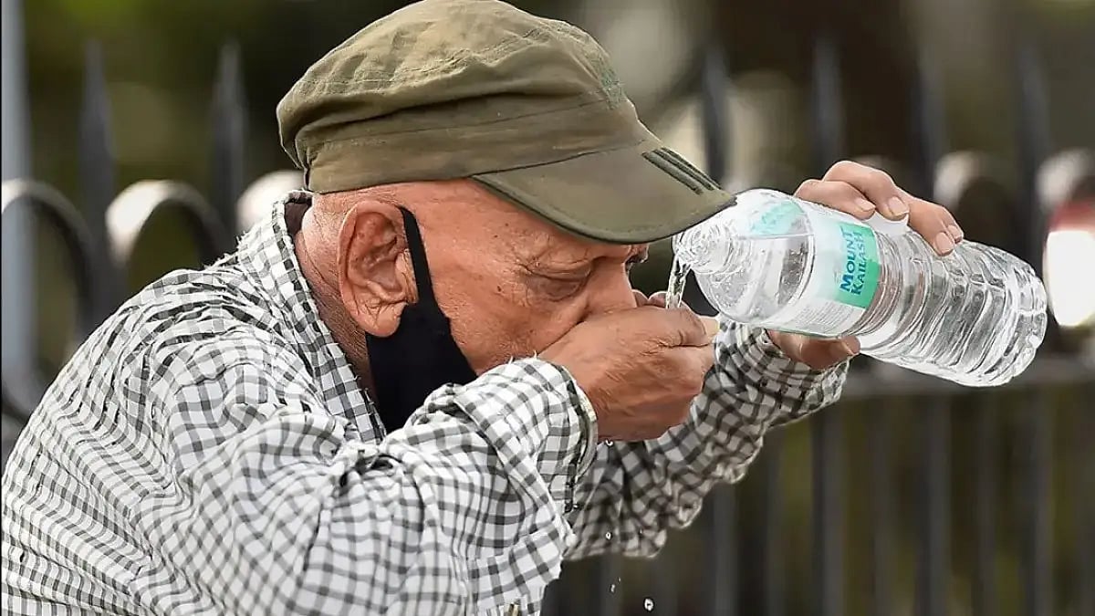 A man drinking water on a hot summer day 
