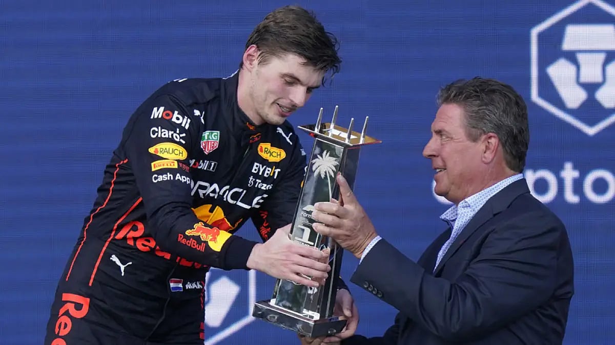 Red Bull driver Max Verstappen receives the winner's trophy from former Miami Dolphins quarterback Dan Marino at the Formula One Miami Grand Prix, May 8, 2022.