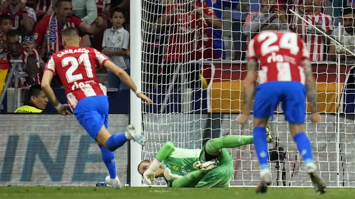 Atletico Madrid's Yannick Carrasco, left, converts a penalty against Real Madrid, May 8, 2022.
