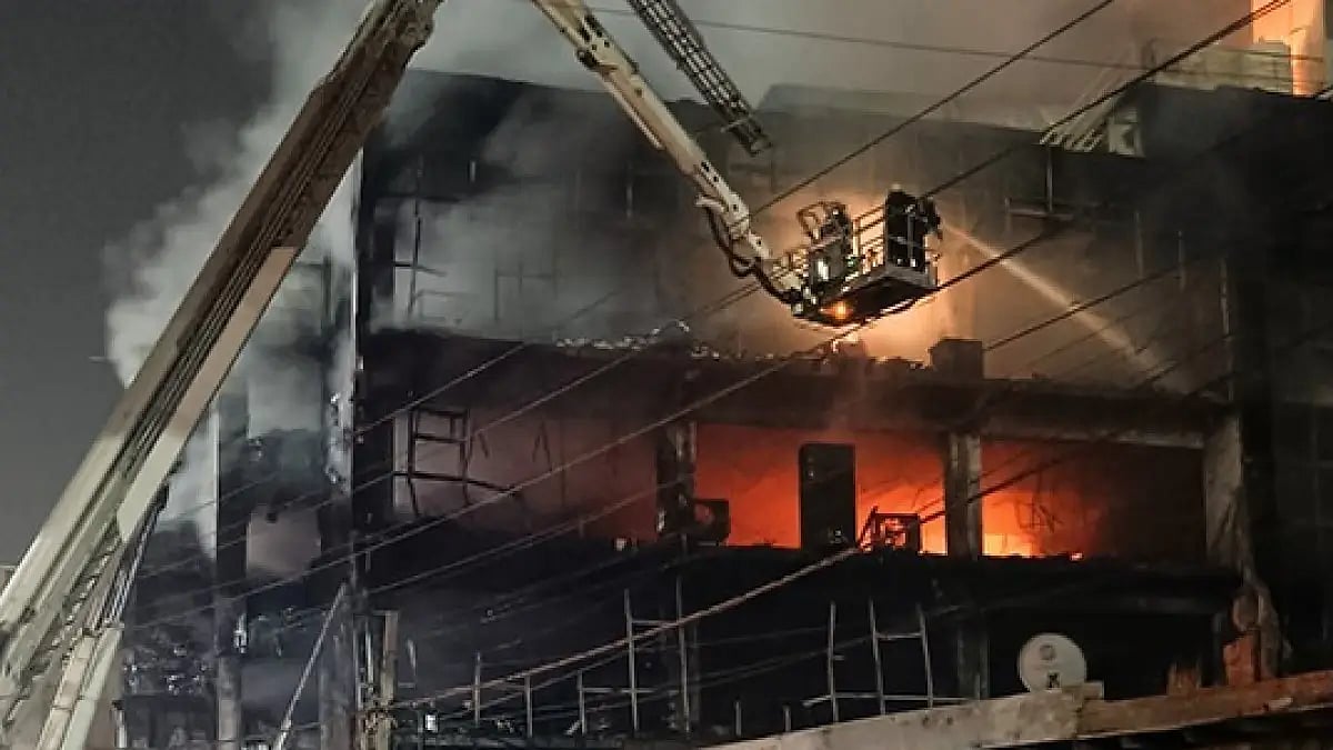 Firefighters try to douse a fire which broke out in a building at Mundka, in West Delhi.