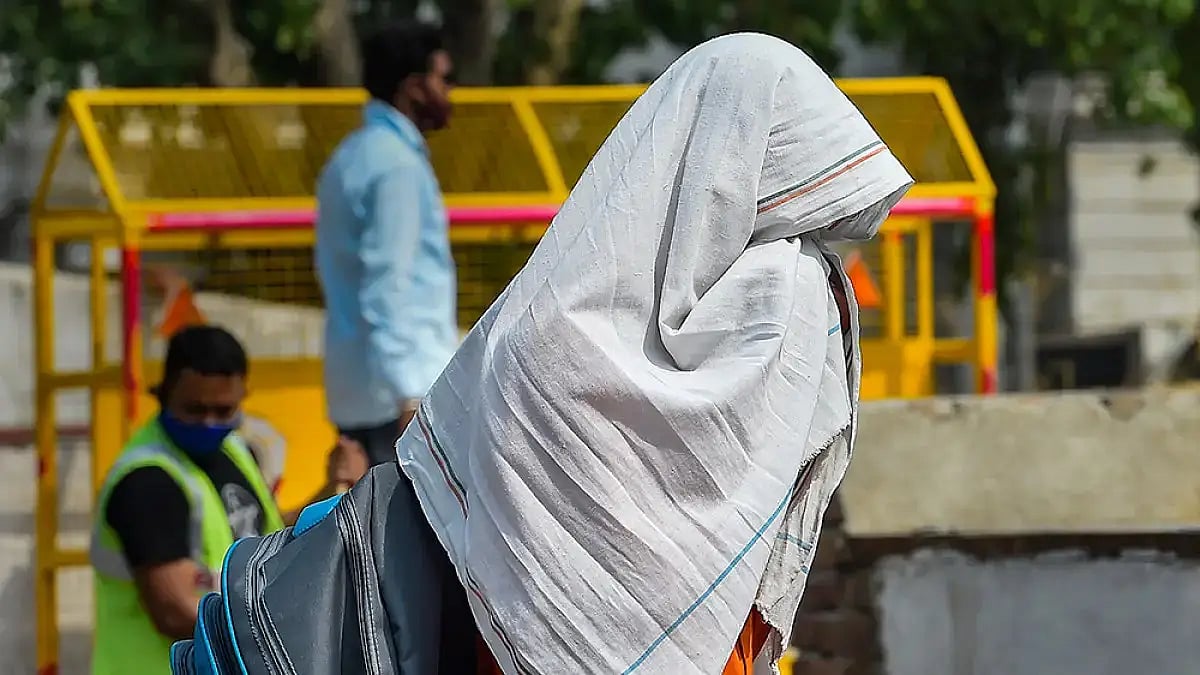 A man covers himself in a hot summer day in Delhi