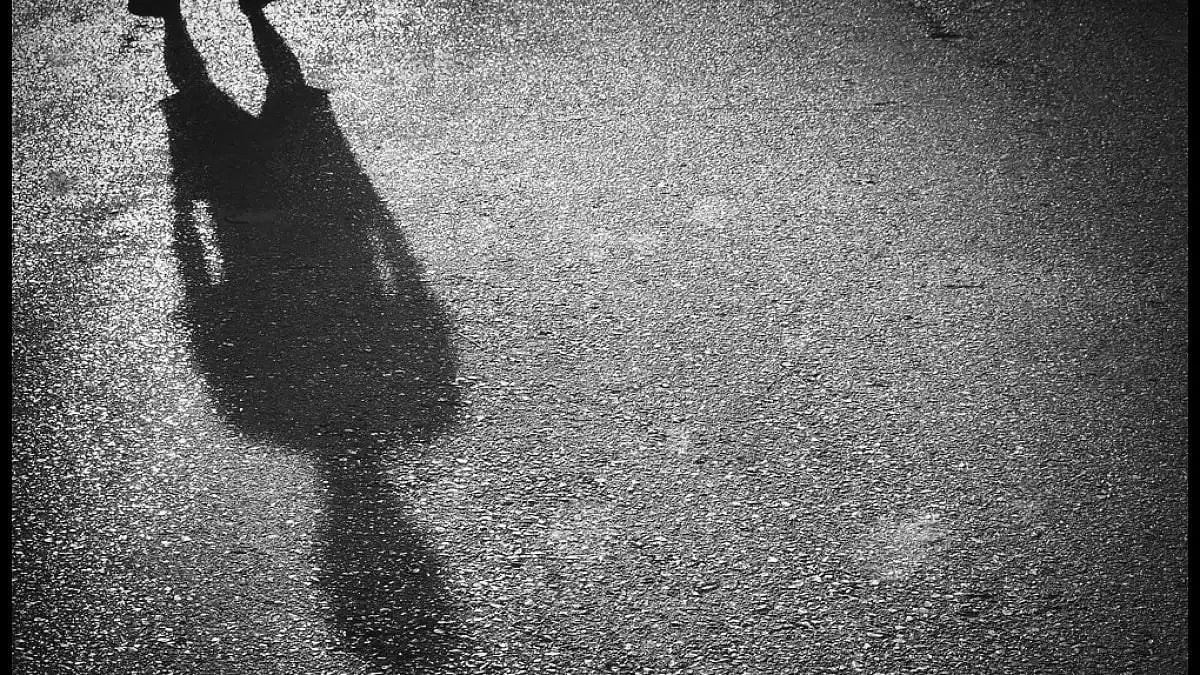 A shadow of a person standing in isolation