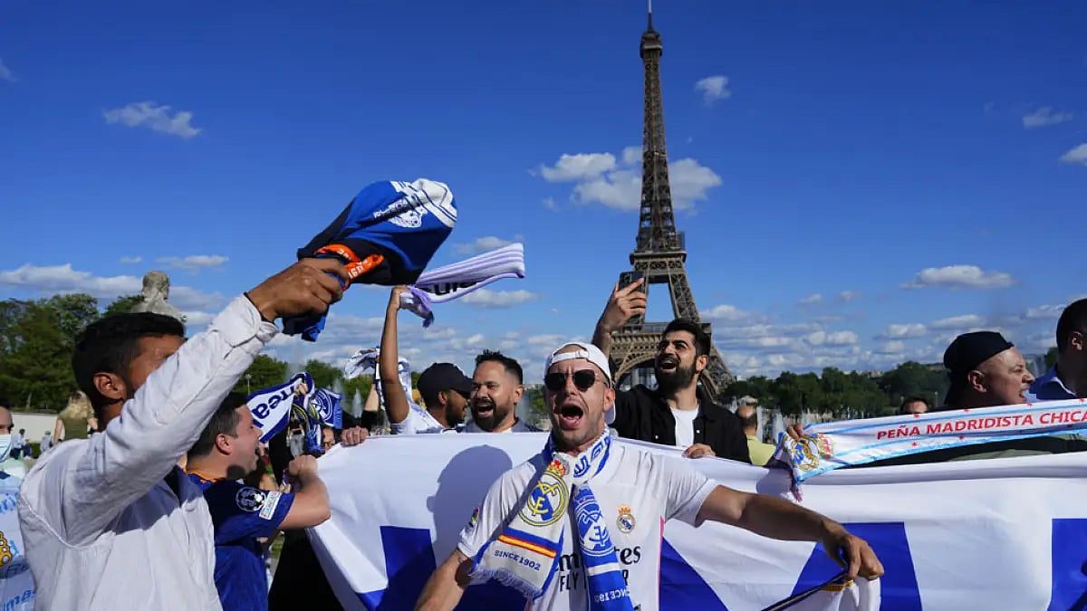 Real Madrid fans cheer in front of the Eiffel Tower Paris, ahead of the UEFA Champions League final.