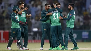 Pakistan's Mohammad Nawaz, center, celebrates with teammates the dismissal of West Indies' Rovman Powell.