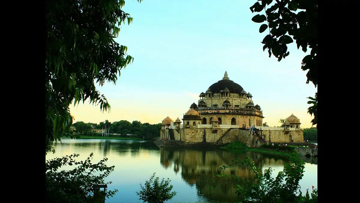 The red sandstone structure stands in the middle of an artificial lake - null