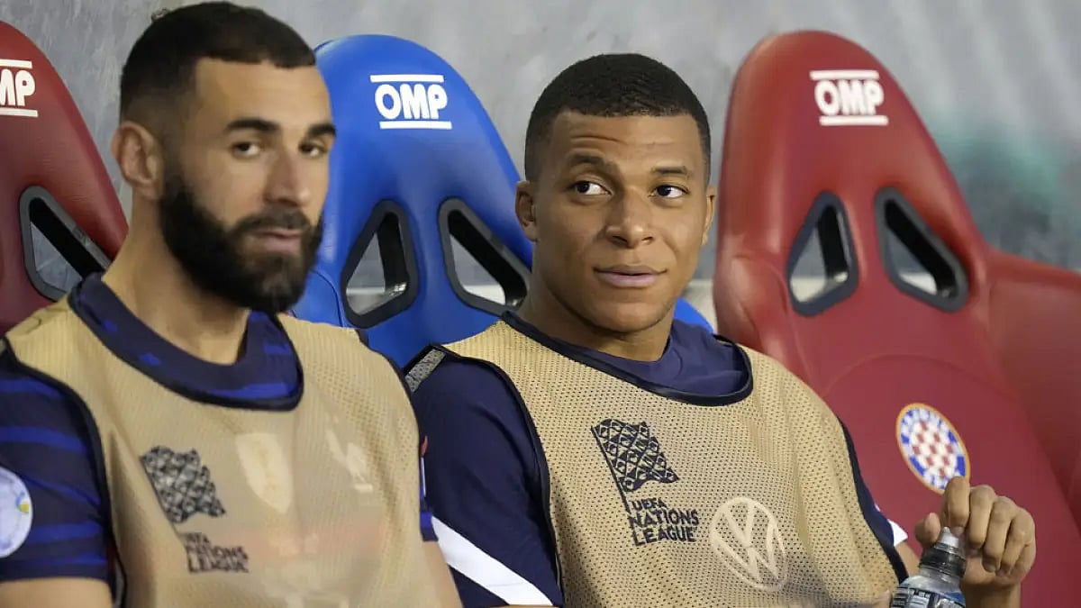 Karim Benzema and Kylian Mbappe look out from the bench during a training session. Watch France vs Croatia football match live.