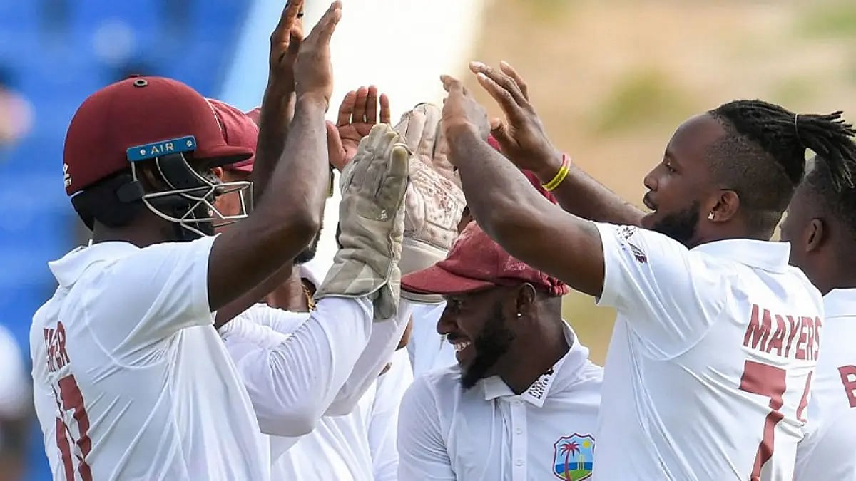 West Indies players celebrate the fall of a Bangladesh wicket during first Test.