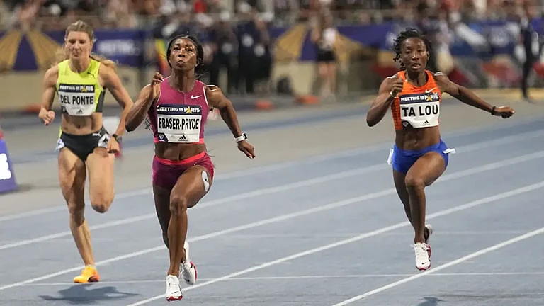 Shelly-Ann Fraser-Pryce of Jamaica, center, runs to win the 100 meters at Paris Diamond League, June 18, 2022. - null