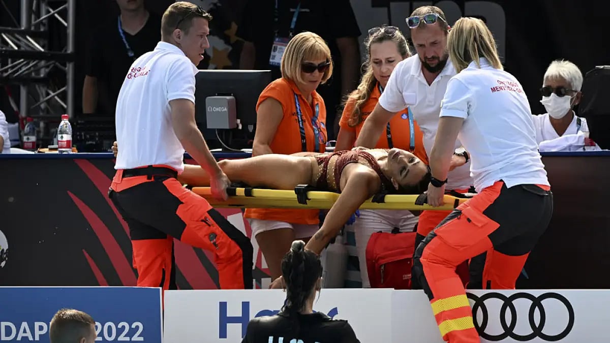 Anita Alvarez is carried on a stretcher after collapsing during the solo free final.