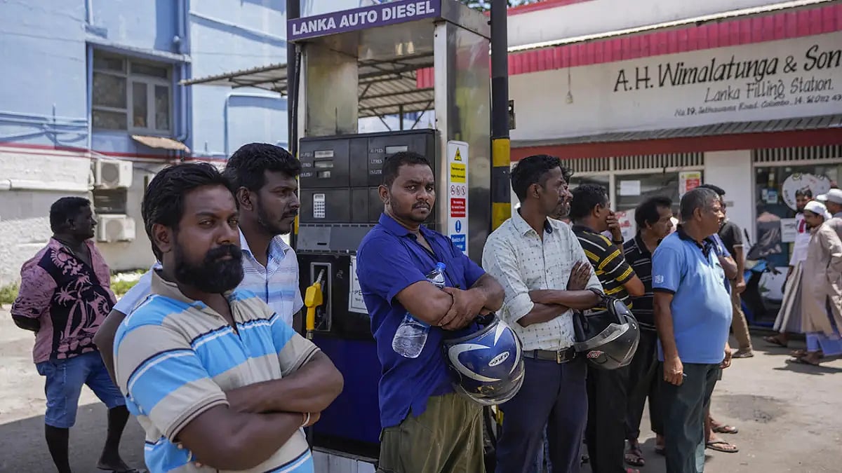 People wait to buy fuel at a fuel station in Colombo, Sri Lanka.