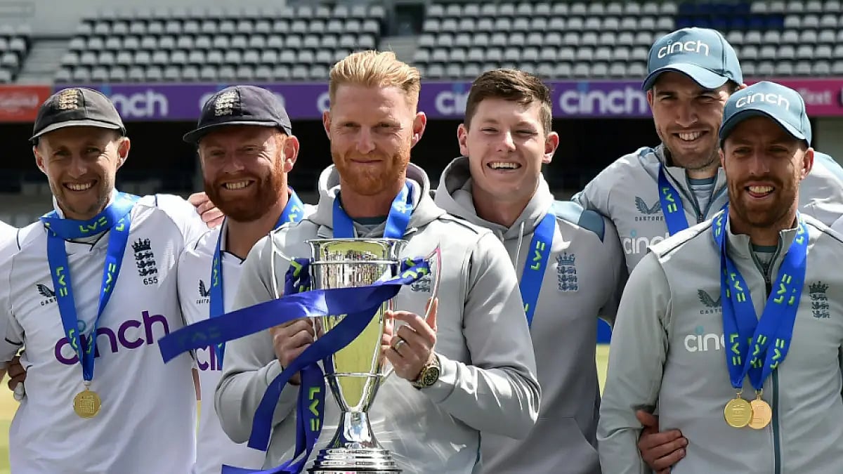 Ben Stokes holds the winners trophy as he poses with England teammates after New Zealand win.