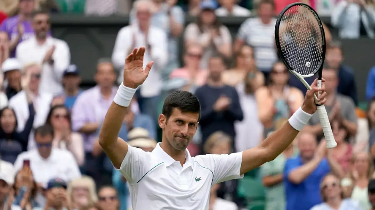 Novak Djokovic acknowledges the crowd after entering Wimbledon 2022 fourth round.  