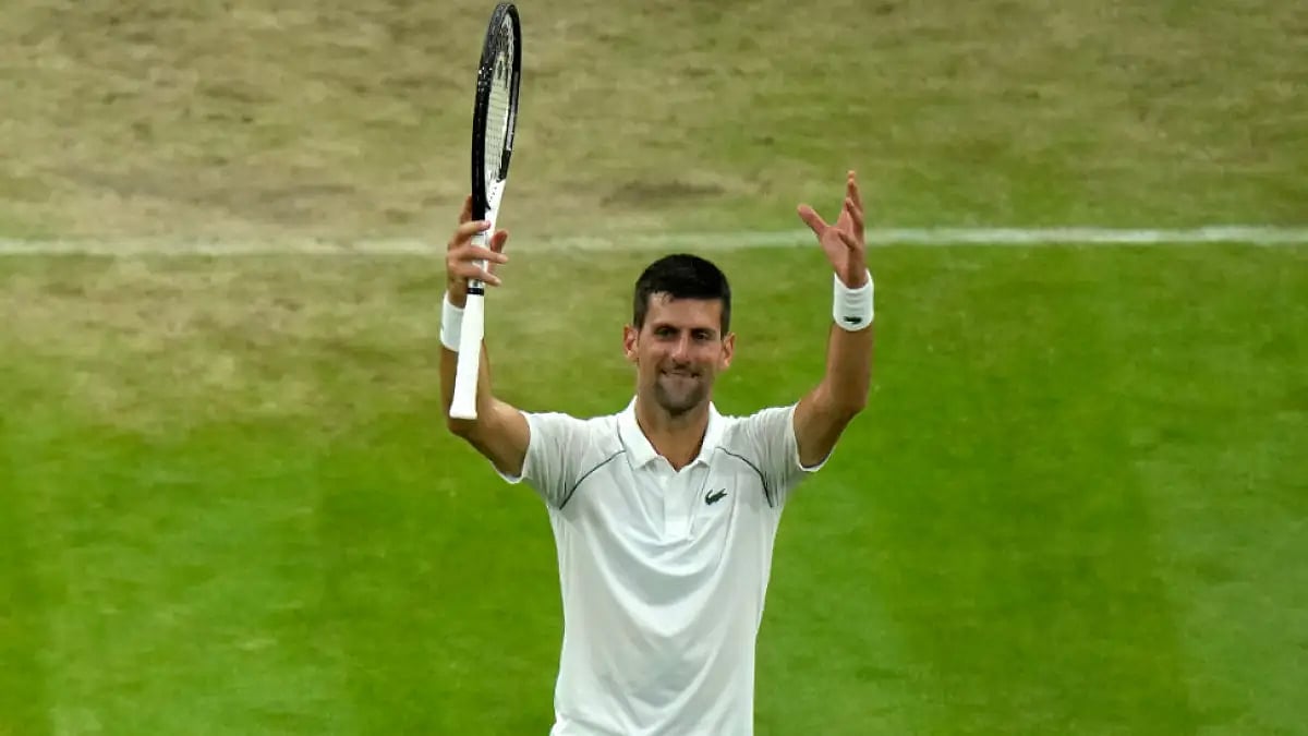Novak Djokovic celebrates after defeating Tim van Rijthoven to reach Wimbledon 2022 quarters.