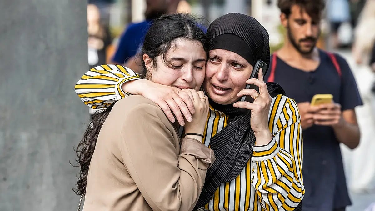 People in front of a mall in which the gunman opened fire at people, killing and injuring several
