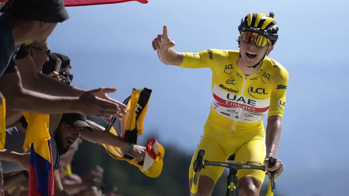Tadej Pogacar celebrates as he crosses the finish line to win the seventh stage of the Tour de France 2022.