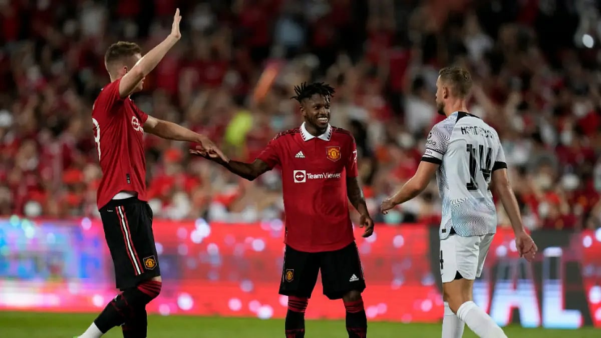 Manchester United's Fred (C) celebrates with a teammate after scoring a goal against Liverpool.