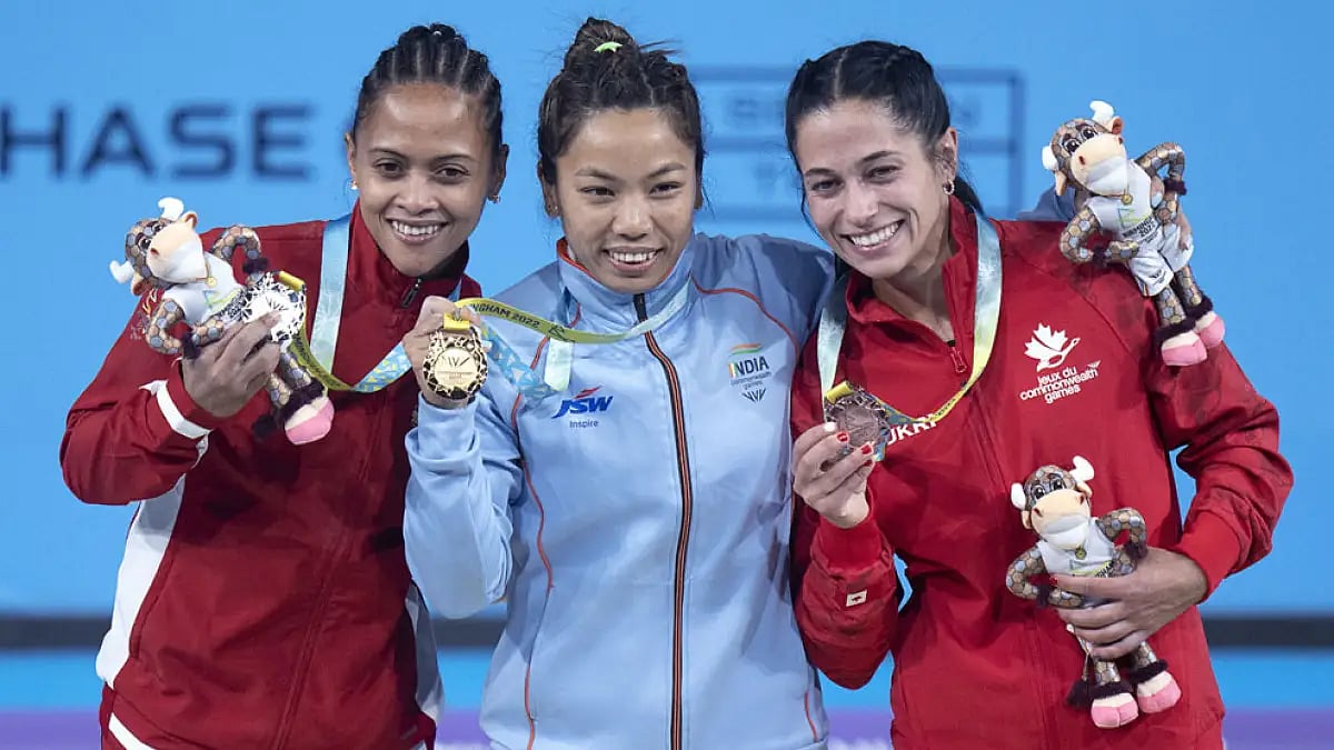 India's Saikhom Chanu Mirabai, center, is flanked by Marie Mauritius' Roilya Ranaivosoa, left, and Canada's Hannah Kaminski. Photo - AP