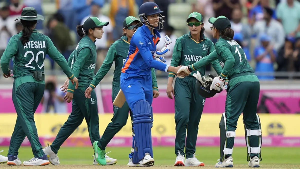 India's Smriti Mandhana with Pakistan cricketers after their match at the Commonwealth Games.