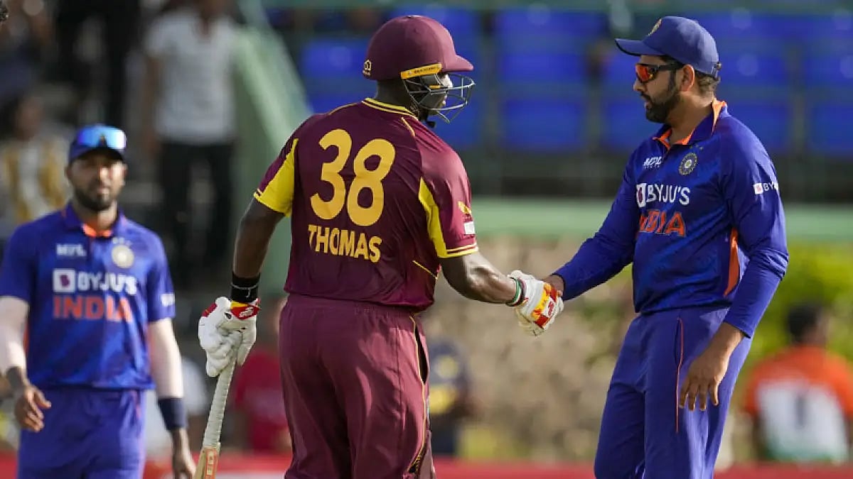 West Indies' Devon Thomas shakes hands with India's captain Rohit Sharma at the end of their second T20I match. - null