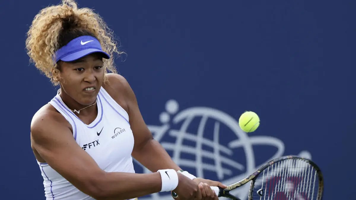 Naomi Osaka returns to Zheng Qinwen during their Silicon Valley Classic tennis match.
