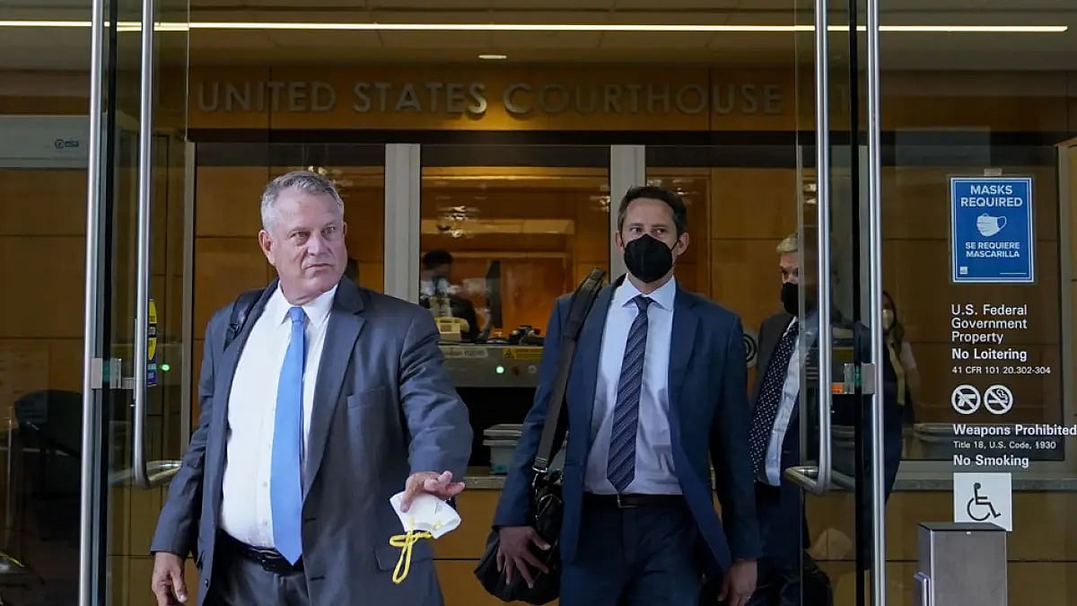 Elliot Peters, left, an attorney representing the PGA Tour, leaves a U.S. courthouse on Aug. 9, 2022