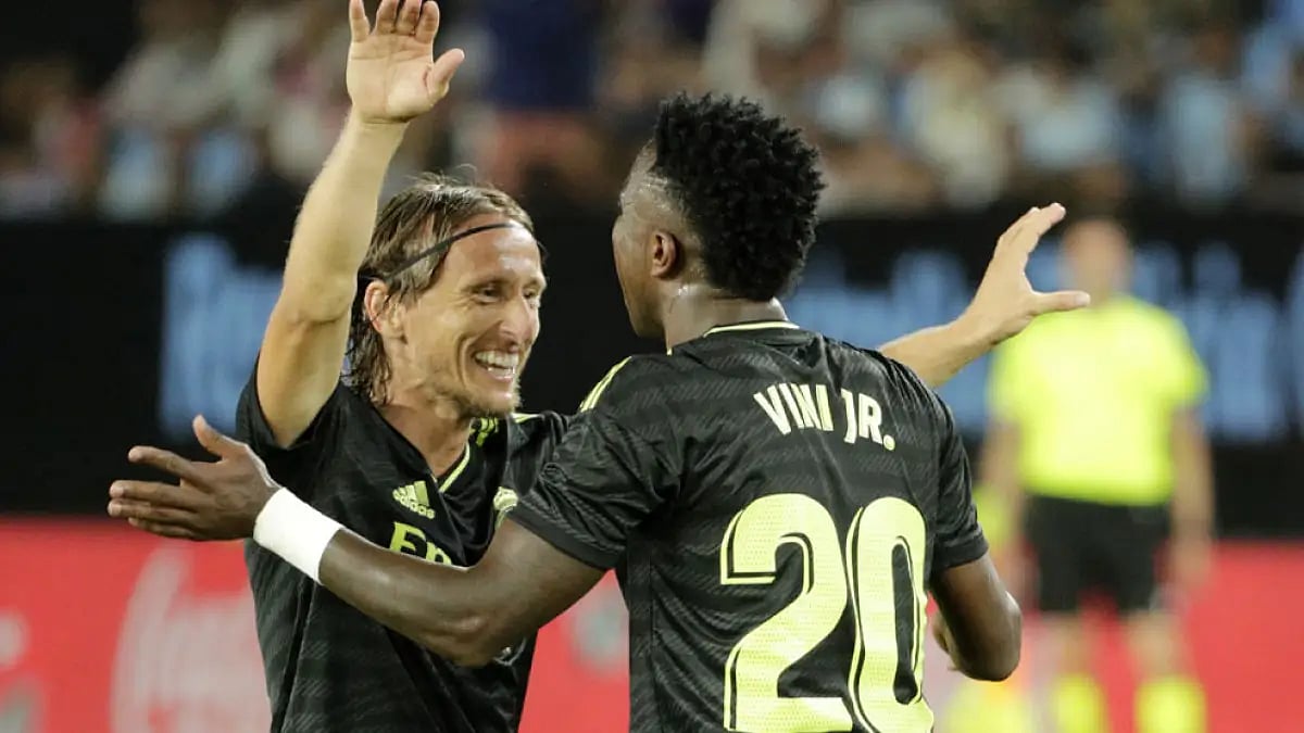 Real Madrid's Vinicius Junior, right, celebrates with Luka Modric a goal against Celta Vigo.