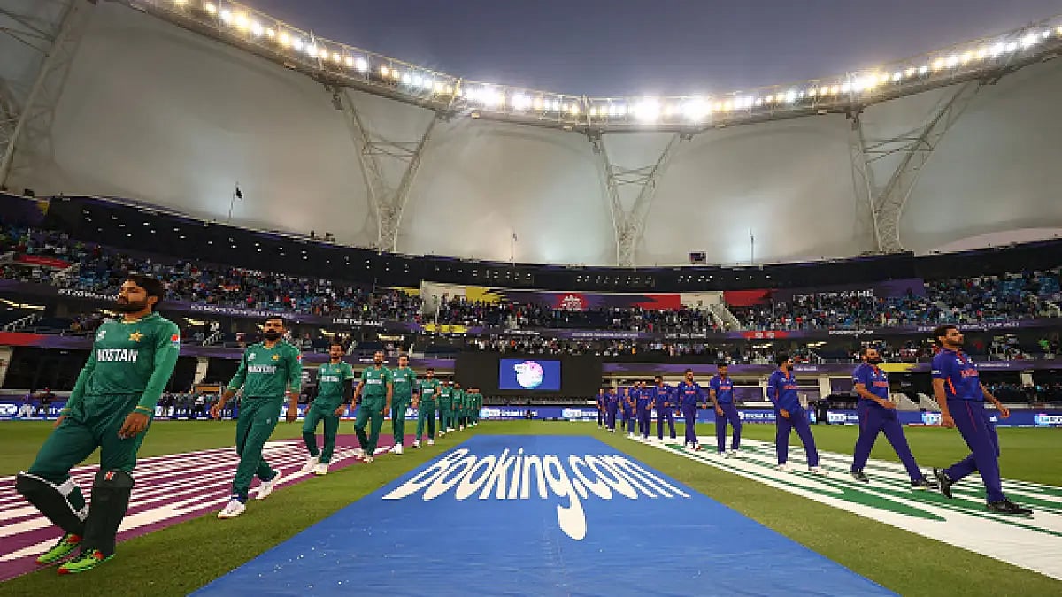 Players of Pakistan and India make their way out for the National Anthems 