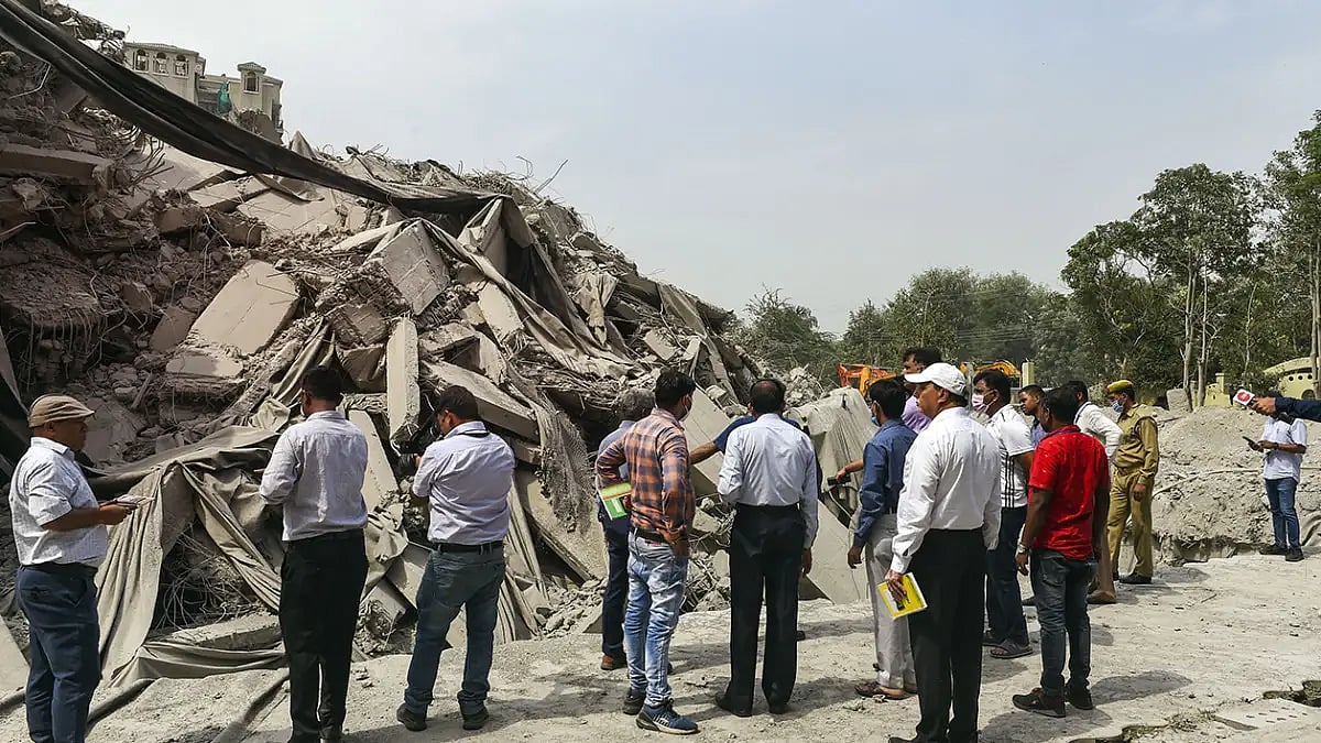 Officials near demolished Supertechs twin towers 