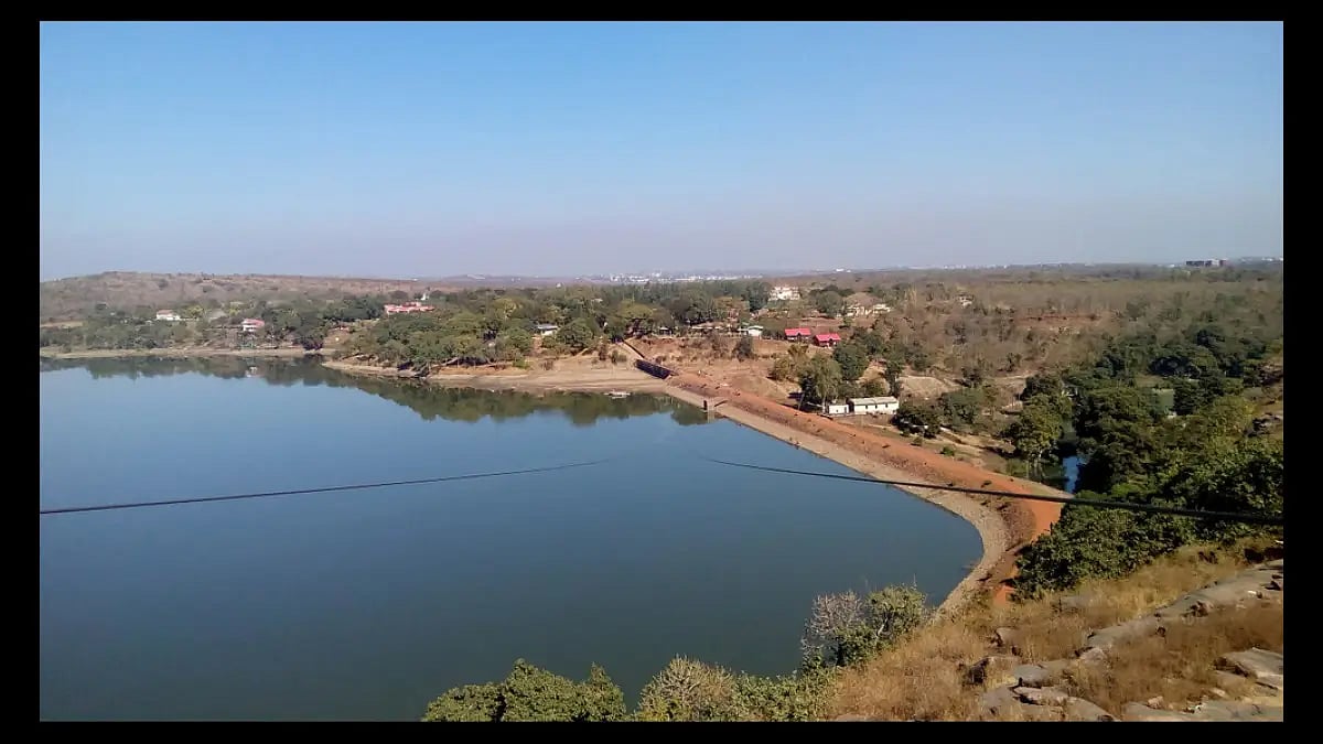 Catch the blue waters of the Kerwa Dam as you go zipping past