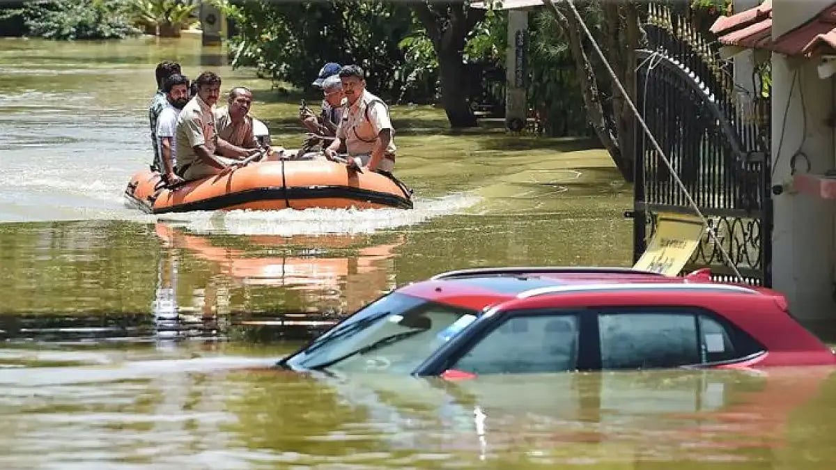 Fire fighters while evacuating residents from flooded Rainbow Drive Layout locality.