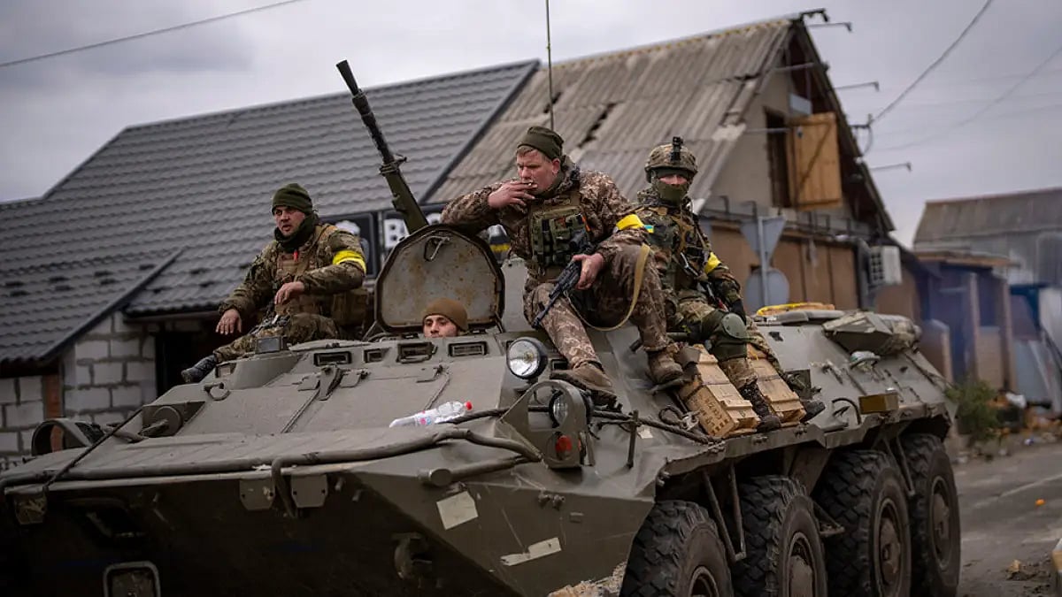 Ukrainian soldiers drive on an armored military vehicle in the outskirts of Kyiv, Ukraine. 