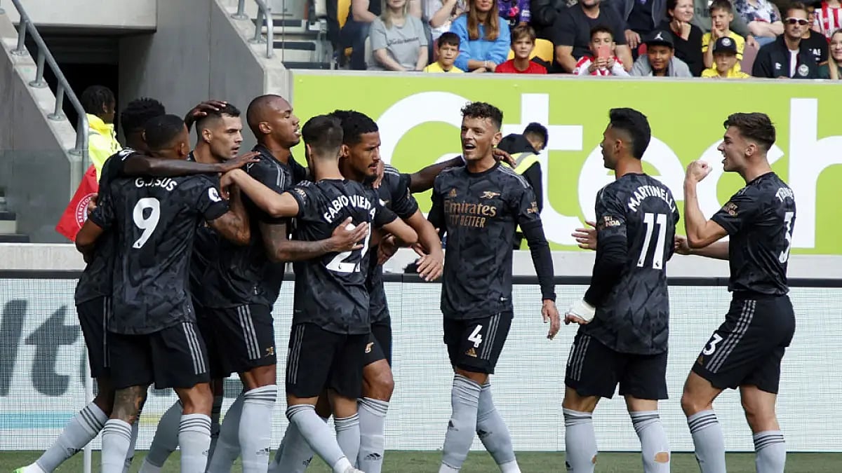 Arsenal players celebrate a William Saliba goal against Brentford.