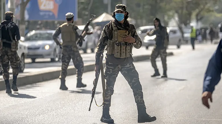 Taliban fighters stand guard at the site of an explosion in Kabul, Afghanistan. (Representative Image) - null
