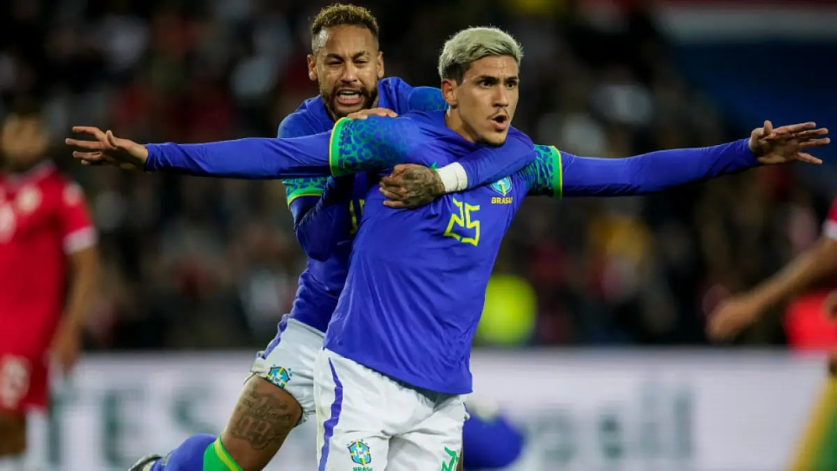 Brazil's Pedro is congratulated by teammate Neymar after scoring against Tunisia in Paris.