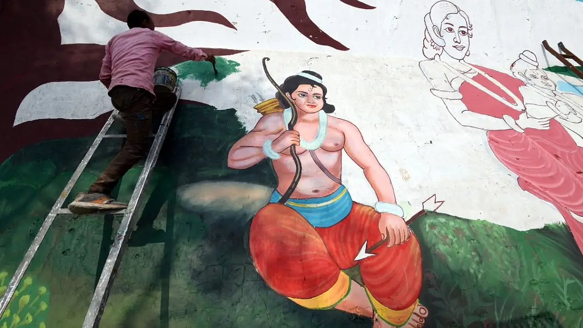 A graffiti artist painting a scene from the Ramayana on a wall in India