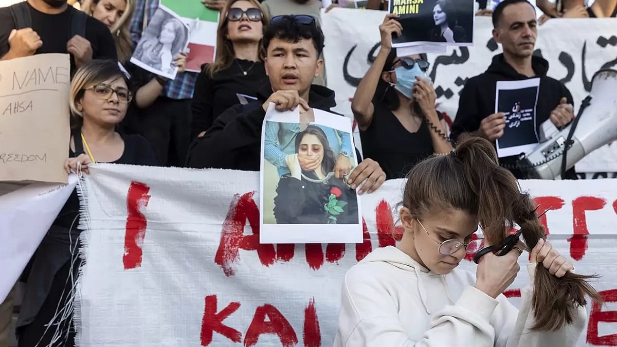 File Photo: A woman cuts her hair during a protest against the death of Iranian Mahsa Amini, at central Syntagma square, in Athens, Greece.