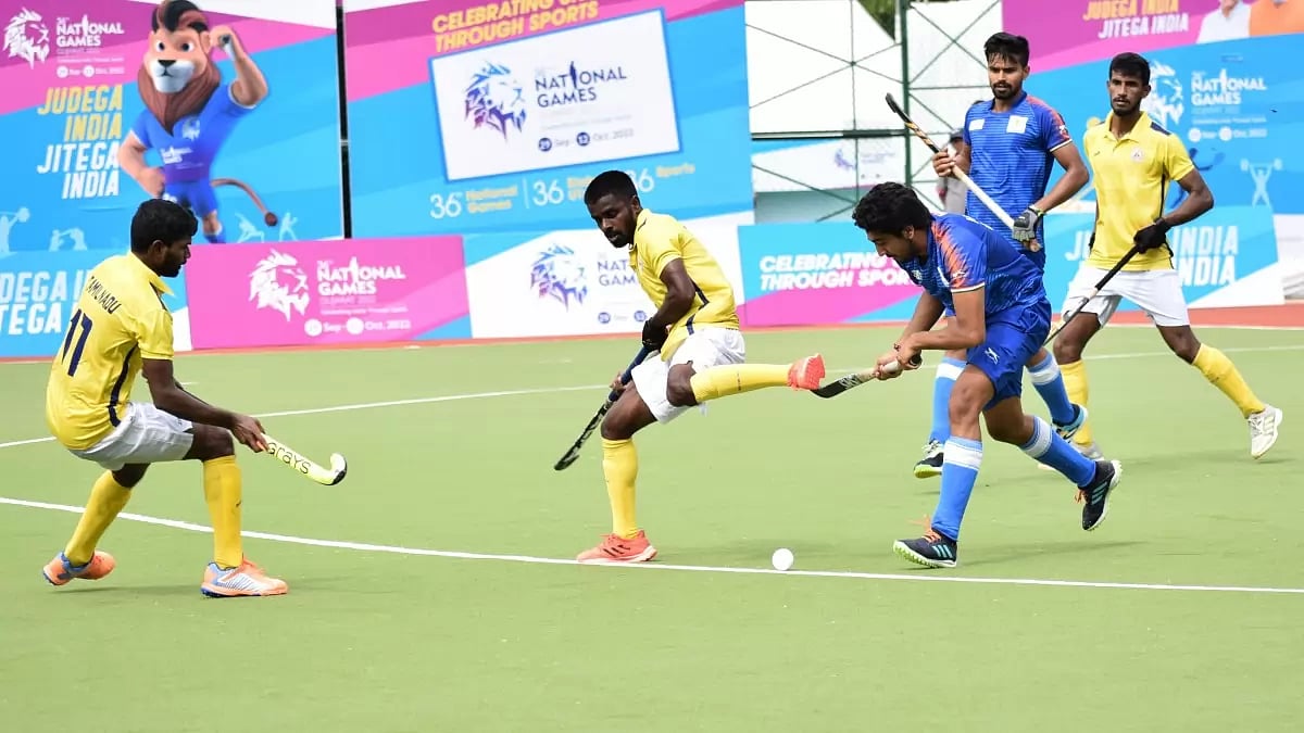 A men's hockey match is underway during the National Games 2022 in Gujarat.
