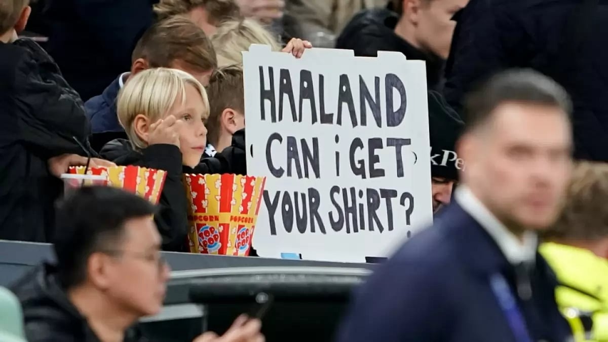 A boy holds up a sign during the Manchester City vs Copenhagen match in UEFA Champions League.