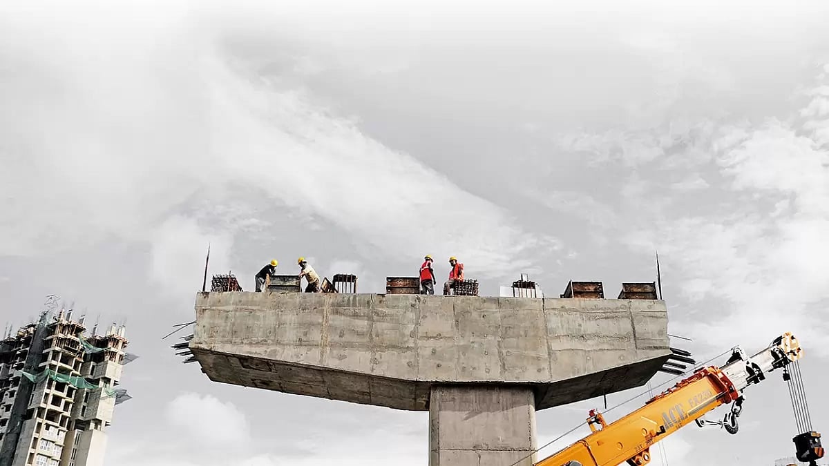 Urbanscape: Labourers surveying the construction work on top of a pillar