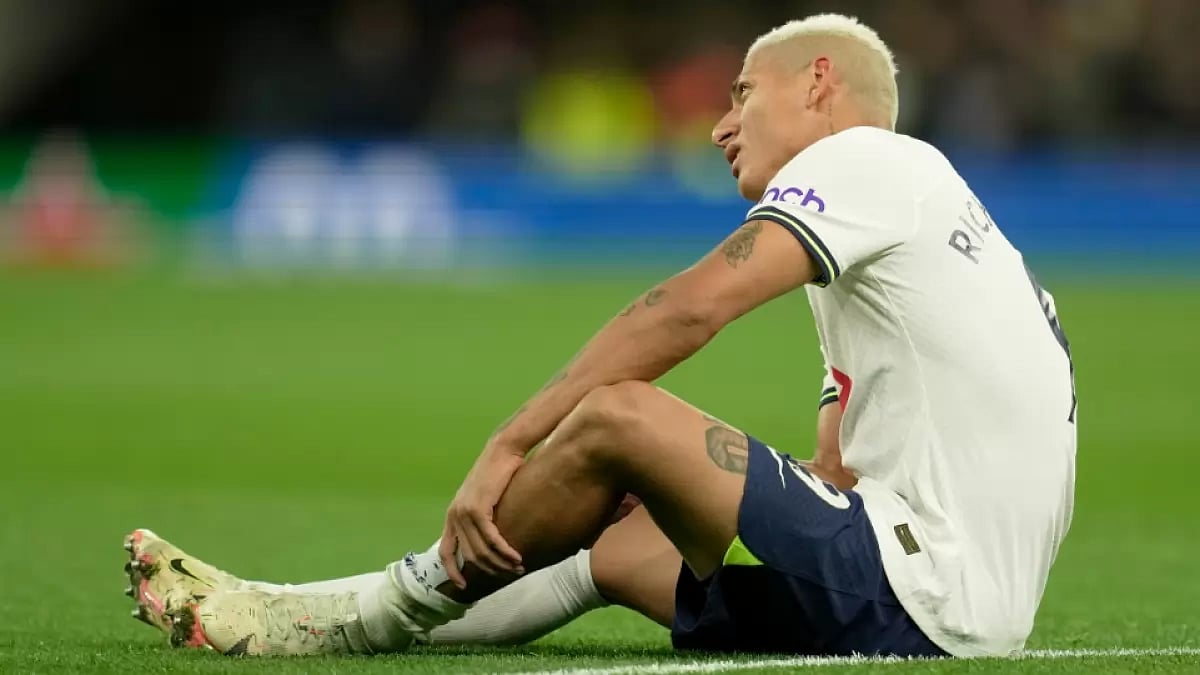 Tottenham Hotspur's Richarlison sits down on the pitch during the EPL match against Everton.