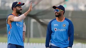 File : Virat Kohli (L) and Rishabh Pant share a light moment during India's training session.