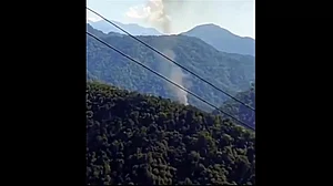 Smoke billows after an light helicopter of the Indian Army crashed at Migging, Upper Siang district