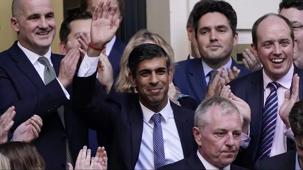 Rishi Sunak, centre, waves after winning the Conservative Party leadership contest