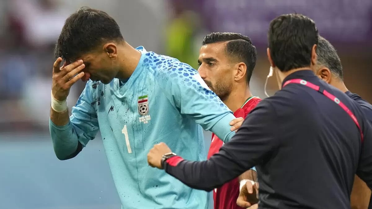 Beiranvand is attended by support staff after colliding with a teammate.