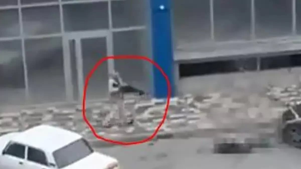 Still from a social media footage showing gunman firing while walking down the street