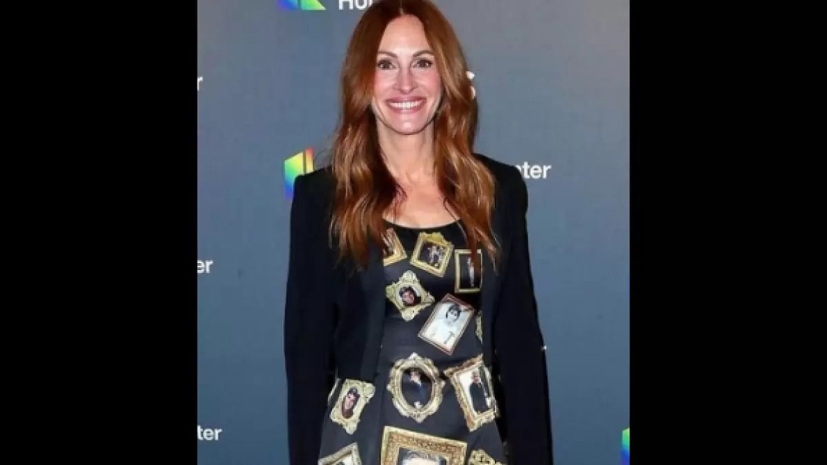 Actress Julia Roberts Wears A Gown With George Clooney's Framed Pictures