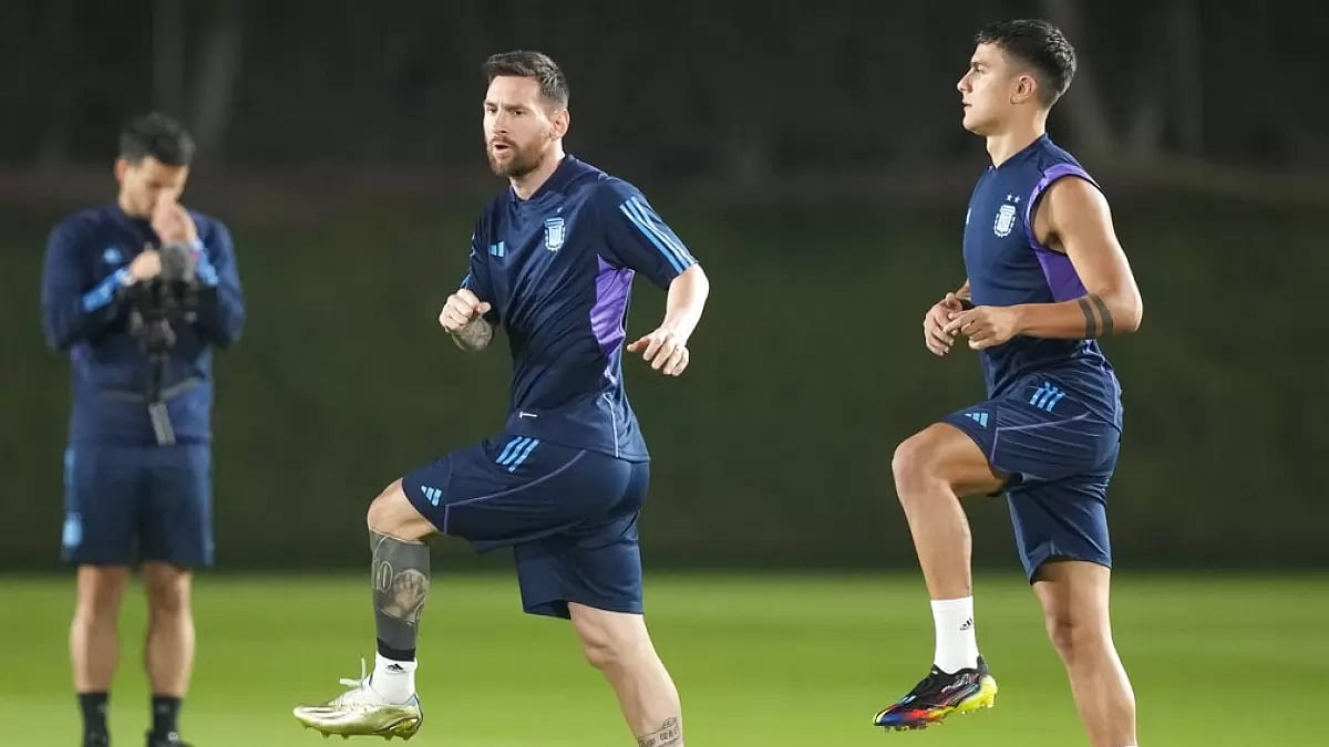 Paolo Dybala (right) warms up with Lionel Messi during a team training session in Doha. 